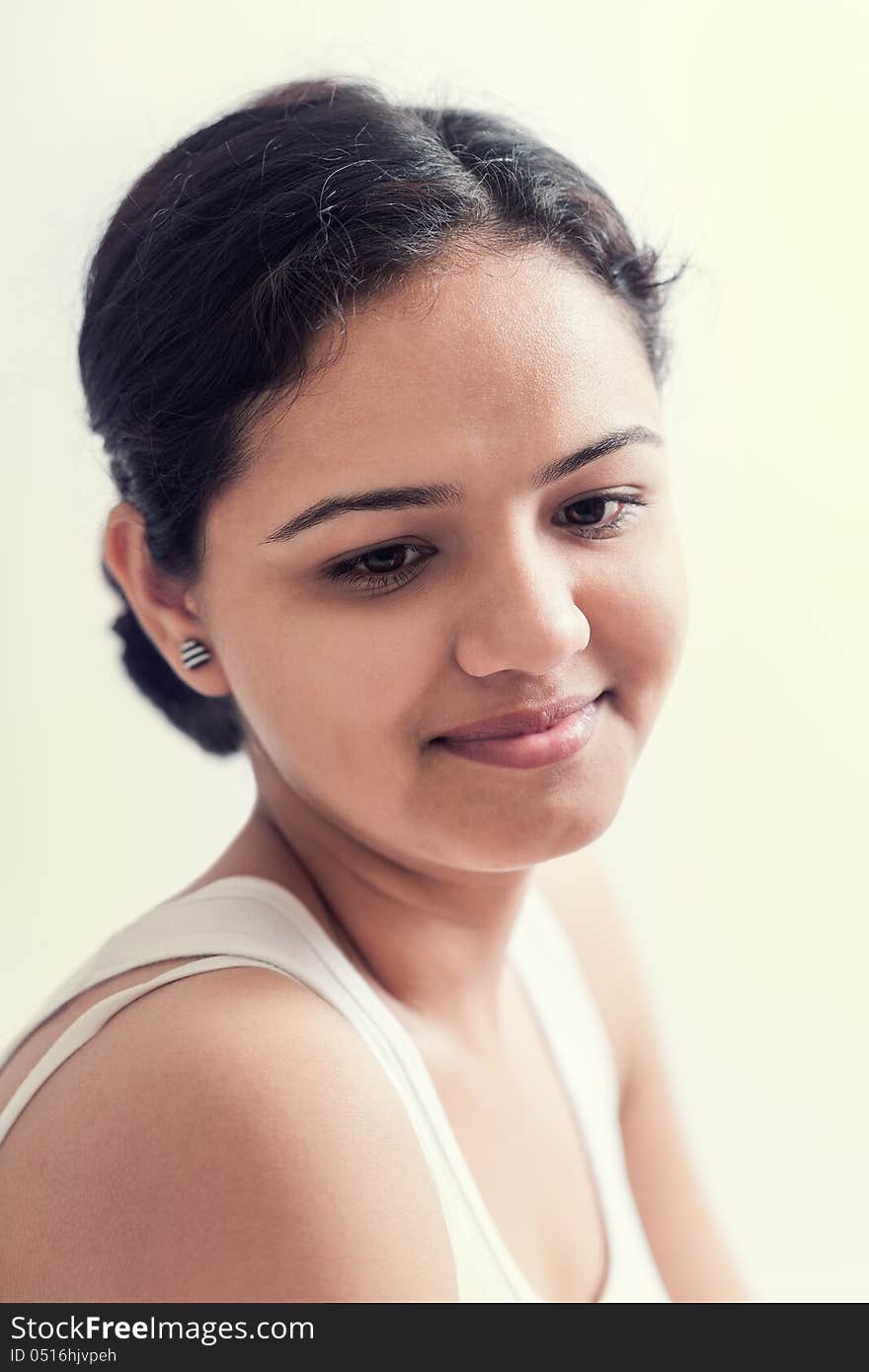 Attractive teenage indian girl smiling and looking down embarrassed. Attractive teenage indian girl smiling and looking down embarrassed.