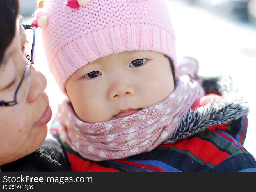 Chinese girl wearing a hat scarf with her mom. Chinese girl wearing a hat scarf with her mom