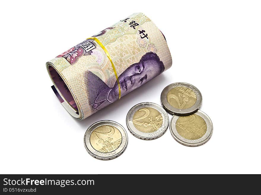 Roll of chinese money and euro coins closeup on white background