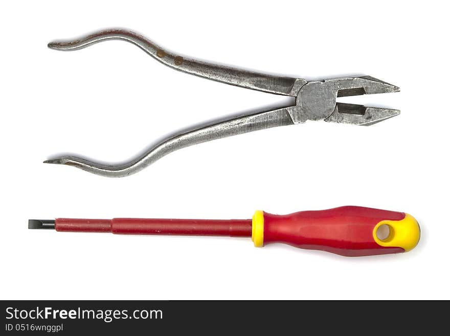 Pliers and screwdriver closeup on white background