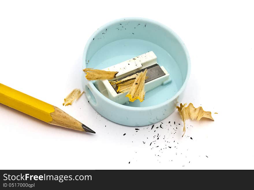 Pencil and sharpener closeup on white background