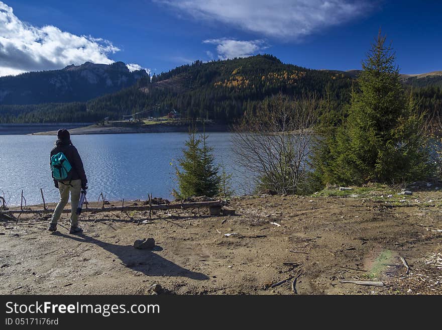 Young girl admires landscape before taking a picture. Young girl admires landscape before taking a picture