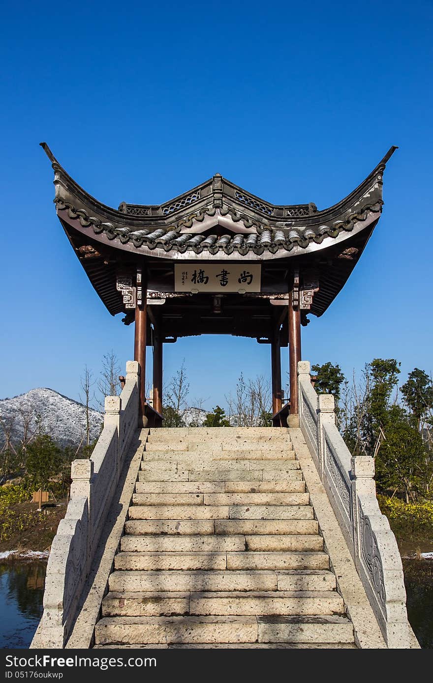 A very nice pavilion under the blue sky, shot in the Xiang Lake. There is also one hill covered by the snow indicate that this picture is taken in the winter. A very nice pavilion under the blue sky, shot in the Xiang Lake. There is also one hill covered by the snow indicate that this picture is taken in the winter.