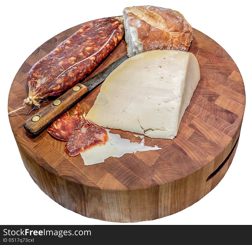 Sliced Italian dry salami with cheese and bread on a wood block cutting board. Sliced Italian dry salami with cheese and bread on a wood block cutting board