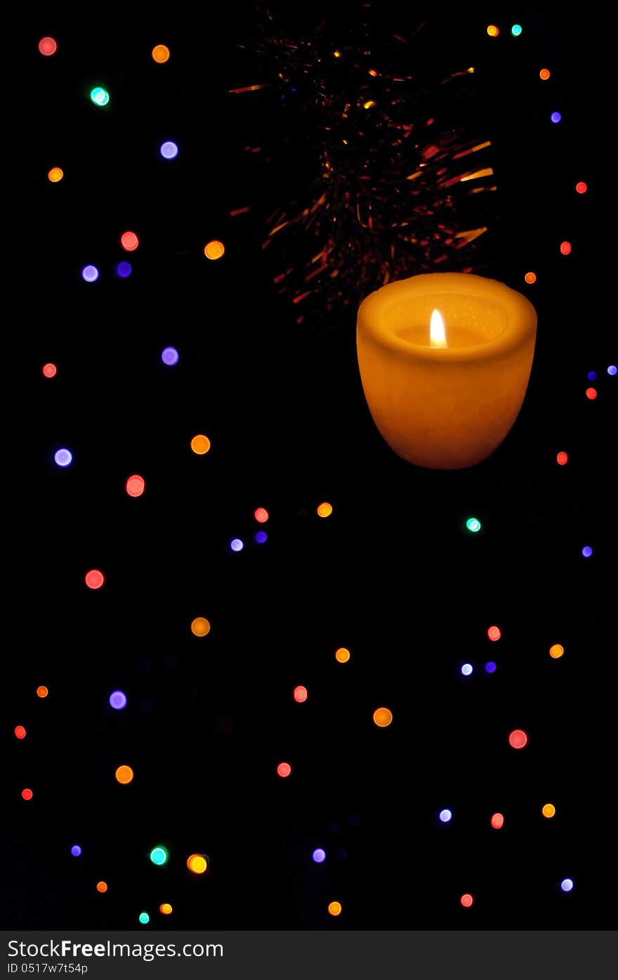 Colored lights over black with candle light. Colored lights over black with candle light