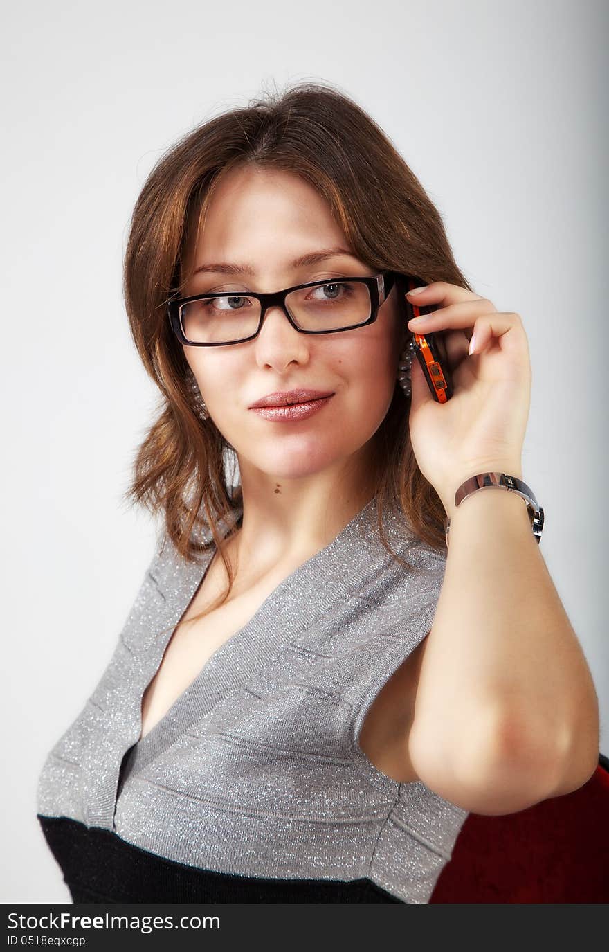 Portrait of pretty girl with mobile phone in the office