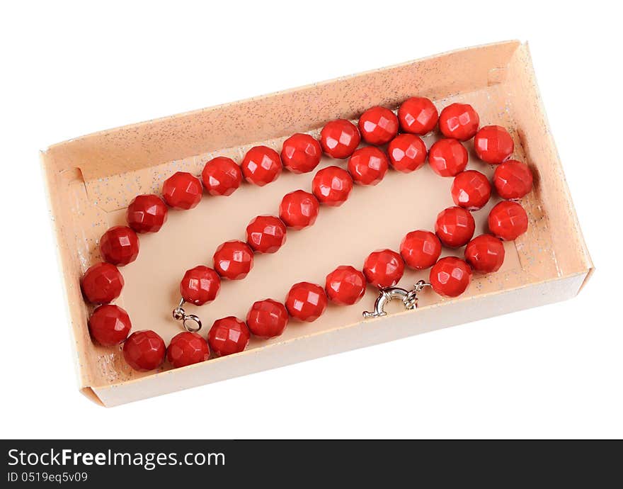 Coral necklace in a paper box isolated on white