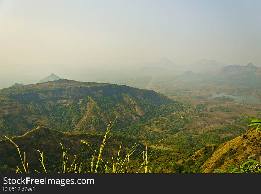 The sunset view beyond the hills in Sayadri range, near Matheran, India. The sunset view beyond the hills in Sayadri range, near Matheran, India.