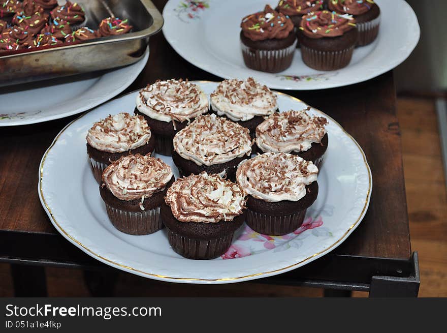 Cupcakes decorates with cream on top.