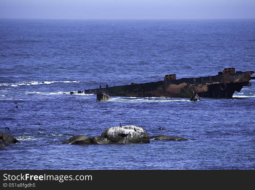 Ship wreck of a ship that ran onto the rock probably more than 100 years ago. Ship wreck of a ship that ran onto the rock probably more than 100 years ago