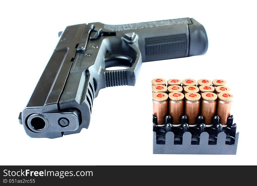 A pistol with bullets isolate on a white background