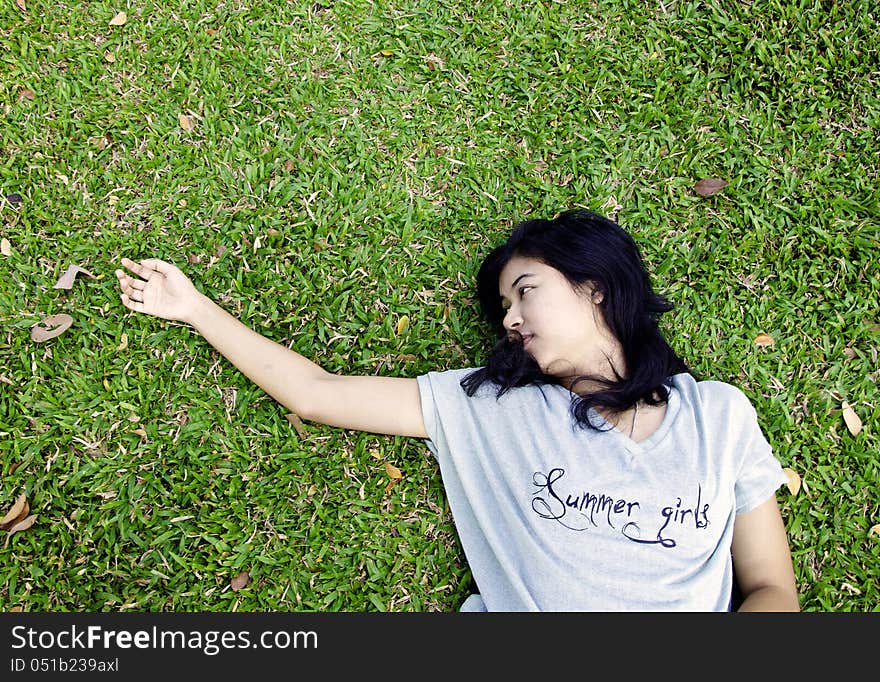 Asian Woman Laying In The Grass