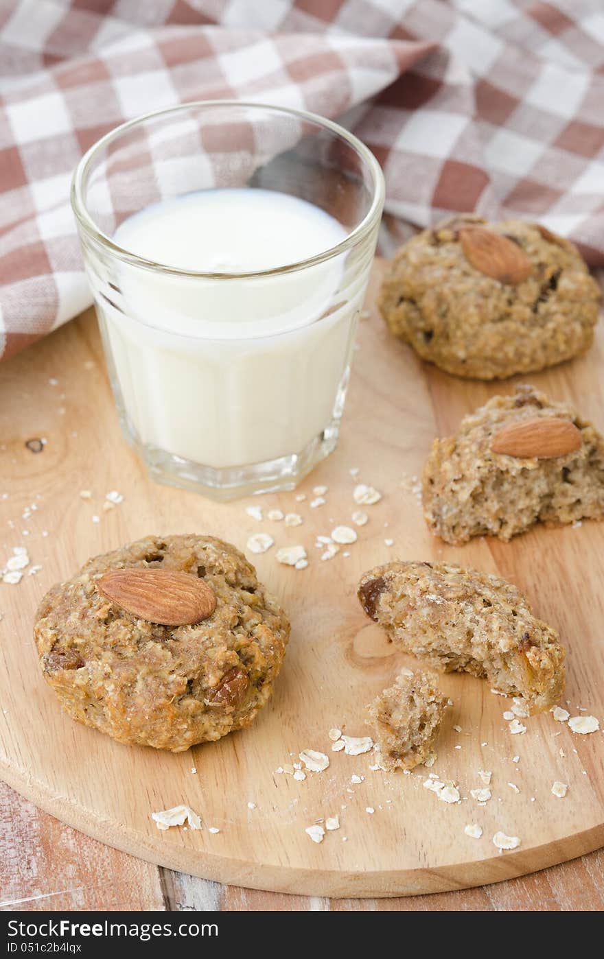 Homemade oatmeal cookies with raisins, spices, nuts and a glass of milk. Homemade oatmeal cookies with raisins, spices, nuts and a glass of milk