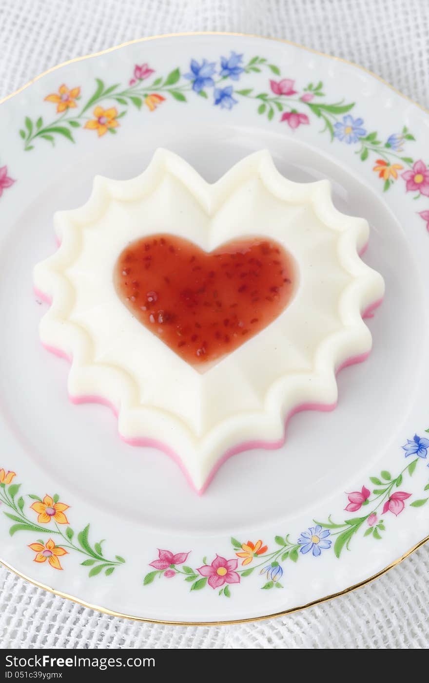 Two-layer  of cream dessert with jam on a plate