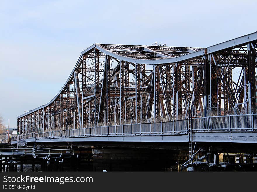 Snow covered old metal bridge