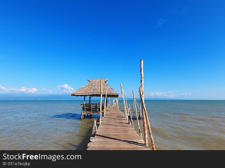 Old wooden boat dock, going far out to sea.