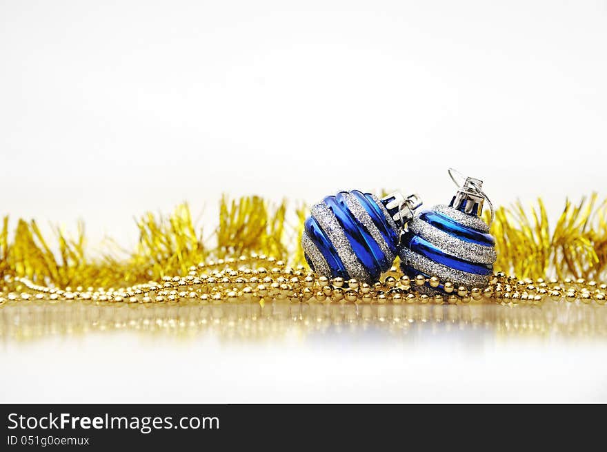 Blue Christmas balls and gold ornaments on a Christmas tree