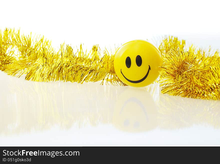 Yellow smile face and gold ornaments. Yellow smile face and gold ornaments