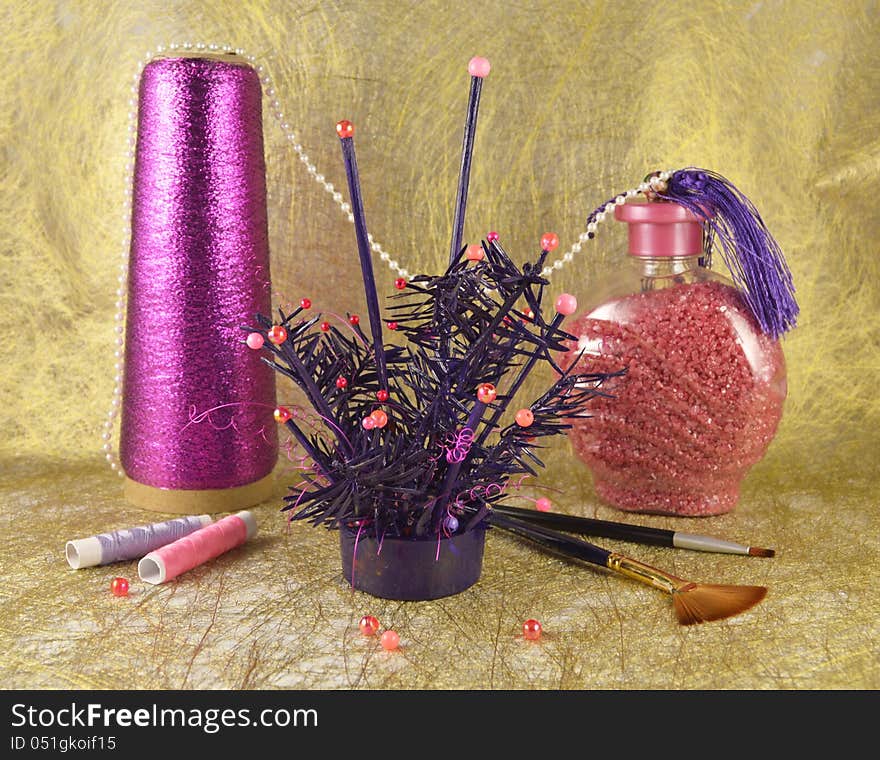 The decoration with dry conifer, beads and jar with pink stones. The decoration with dry conifer, beads and jar with pink stones