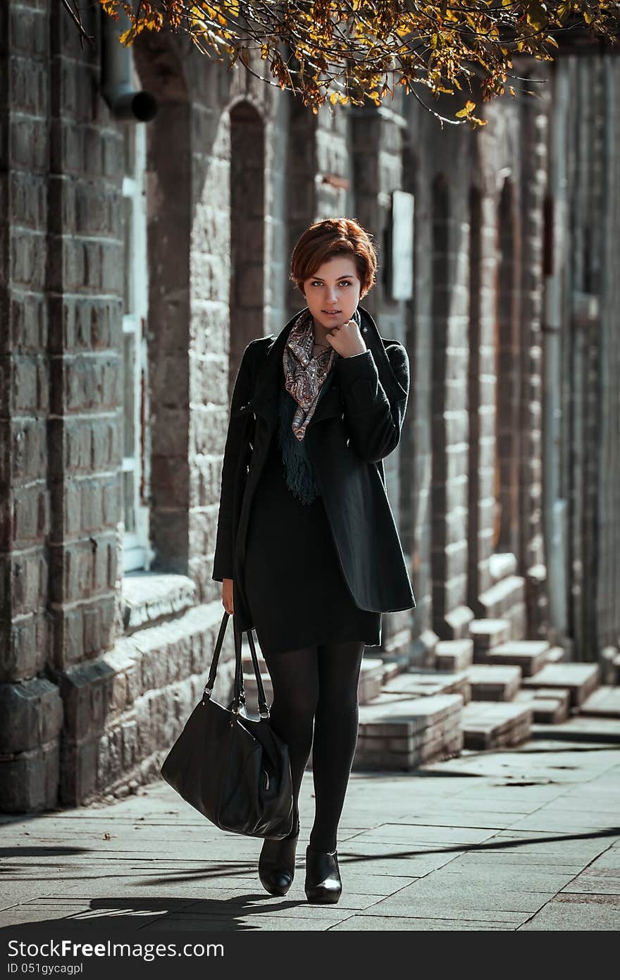 Beautiful young woman walking on the street