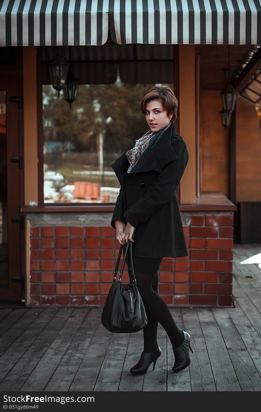 Beautiful young woman walking on the street. This image has attached release.