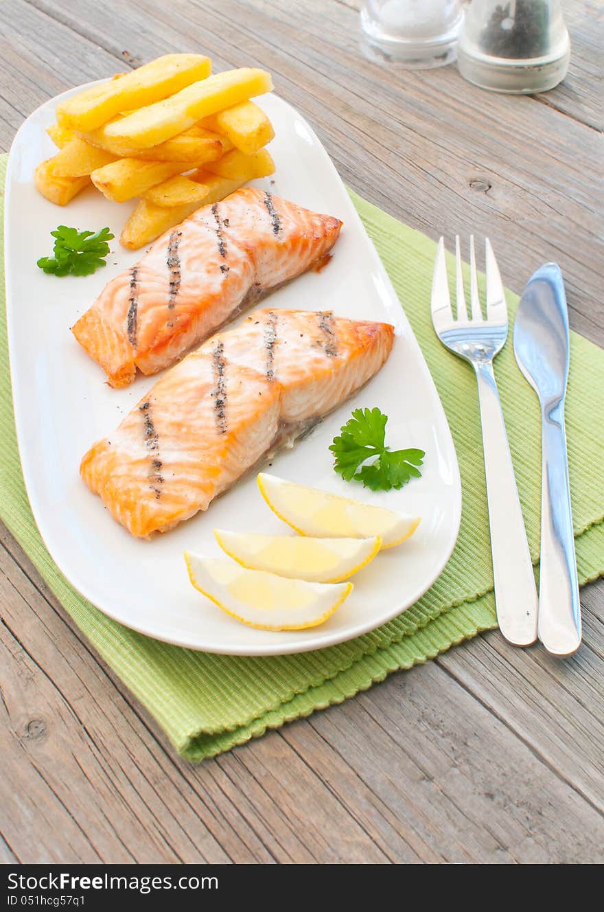 Grilled salmon fillets with chips. Grilled salmon fillets with chips