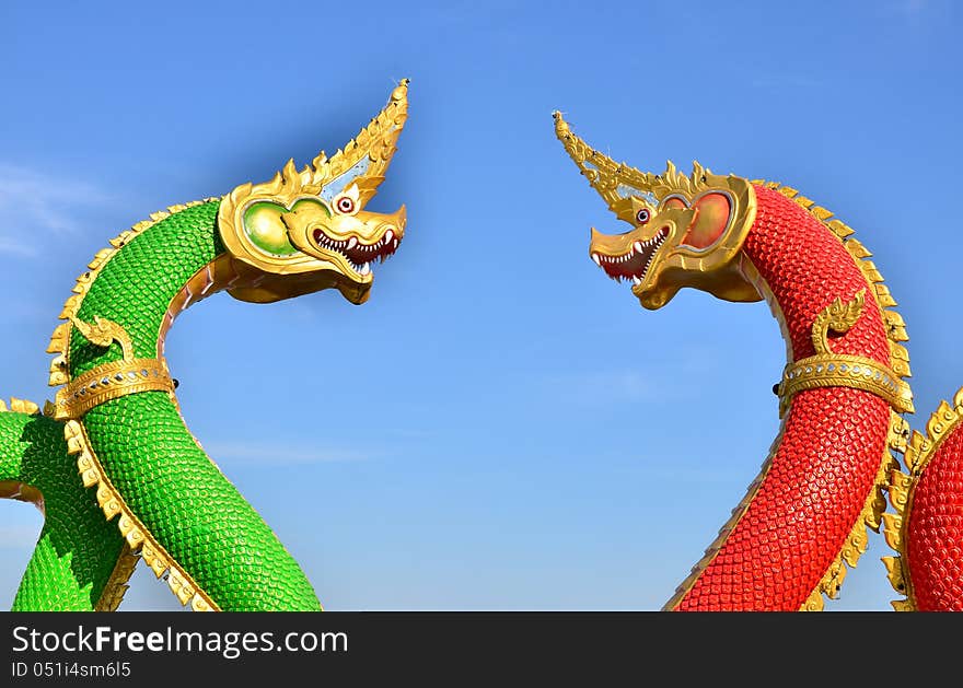 Big green and red serpents staue in temple of Thailand