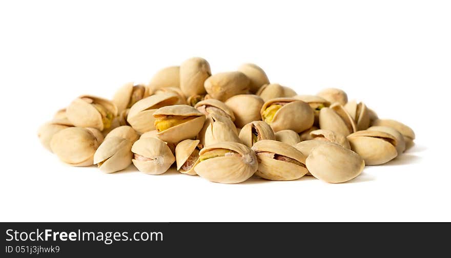 Delicious cracked pistachio nuts isolated on white background