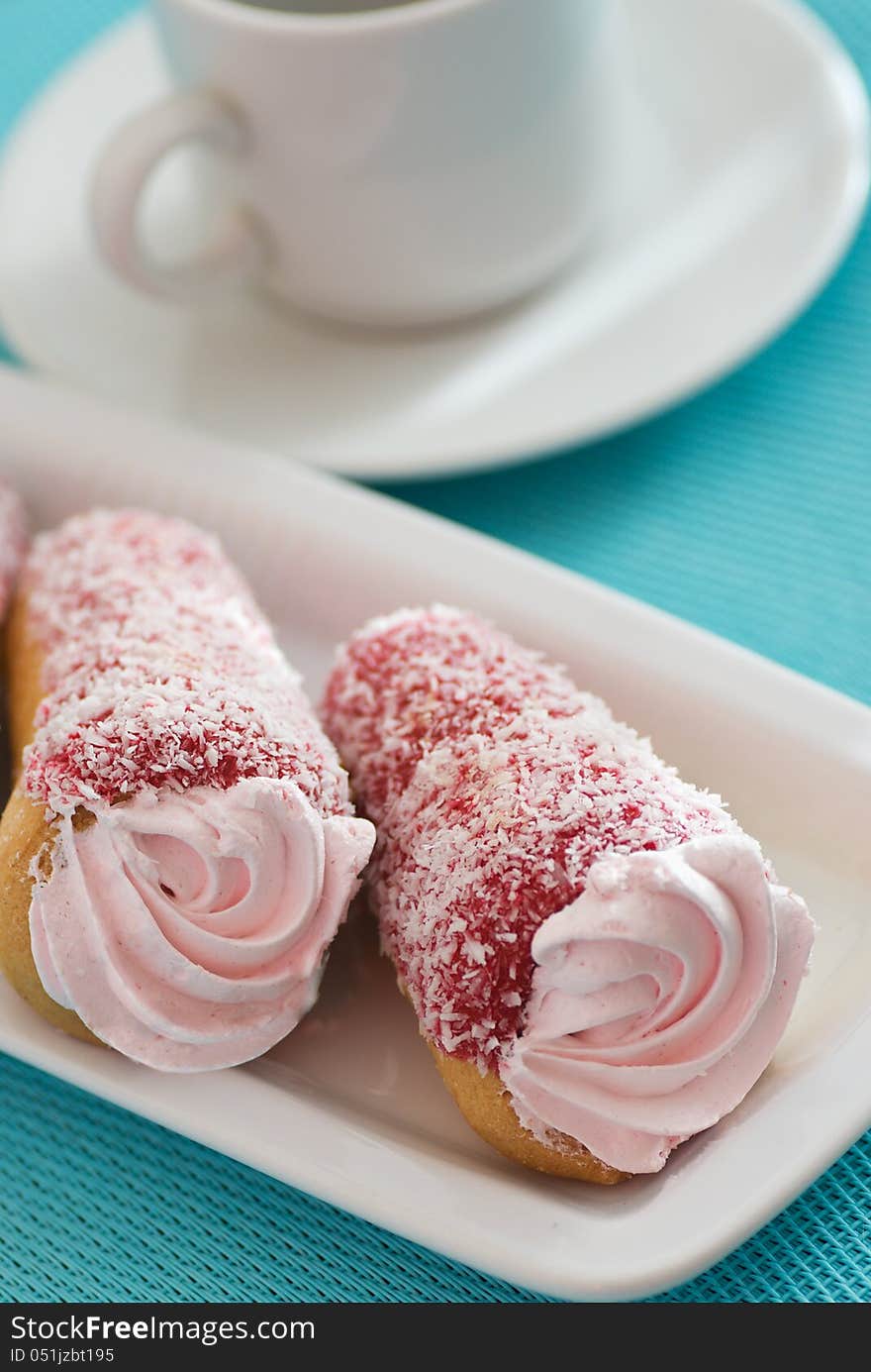 Two cakes with pink cream on a blue background