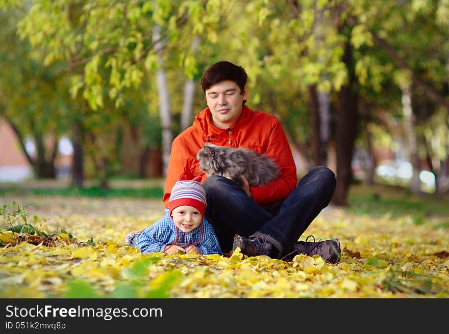 Family with cat in the autumn park