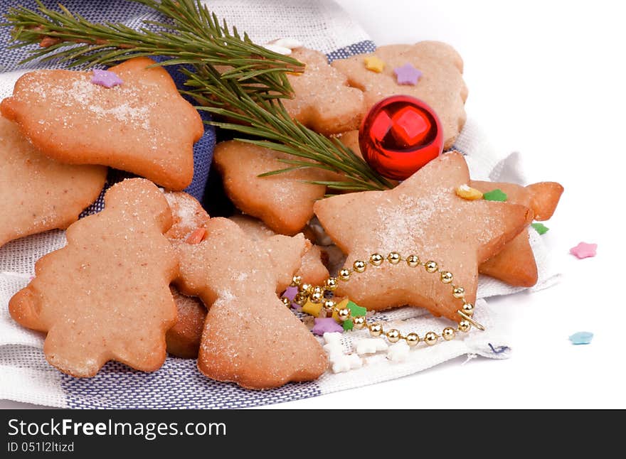 Gingerbread Christmas Cookies decorated with Colorful Candy, Sugar Powder and Fir closeup on Napkin