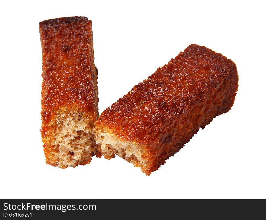 Broken in half roasted crouton closeup isolated on a white background. Broken in half roasted crouton closeup isolated on a white background