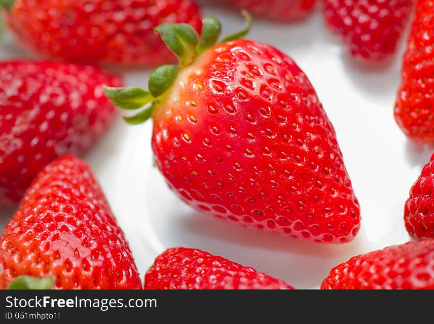 A detail of strawberries on white. A detail of strawberries on white