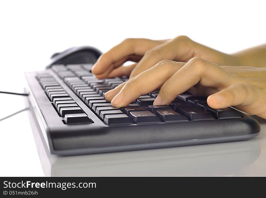 Woman hand typing on black computer keyboard isolated over white background. Woman hand typing on black computer keyboard isolated over white background