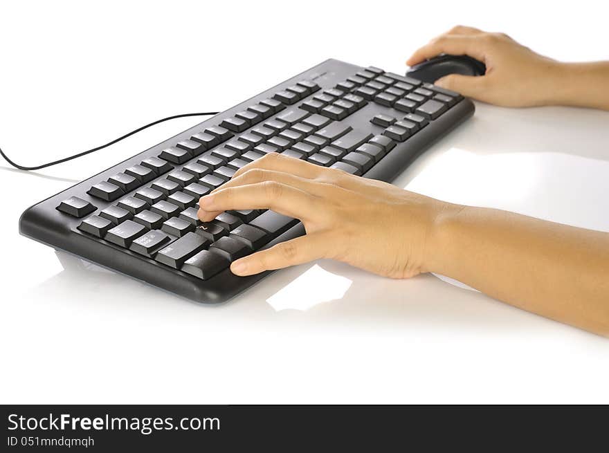 Woman hand typing on black computer keyboard over white background. Woman hand typing on black computer keyboard over white background