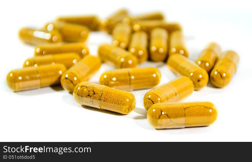 Herbs capsules.  on white background. Shallow DOF