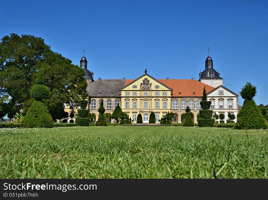 Historic baroque castle in Hundisburg with trees and well-kept lawn. Historic baroque castle in Hundisburg with trees and well-kept lawn