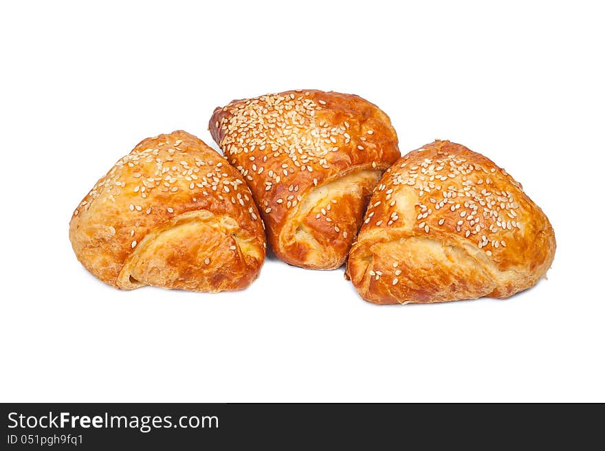 Pies from flaky pastry strewed with sesame seeds. Pies from flaky pastry strewed with sesame seeds