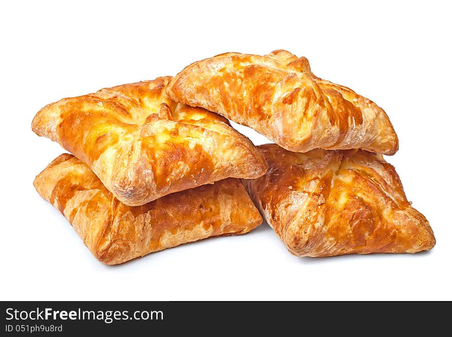 Four pies from flaky pastry on a white background