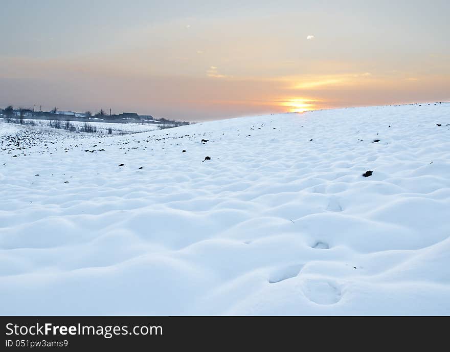 Snow field at sunset