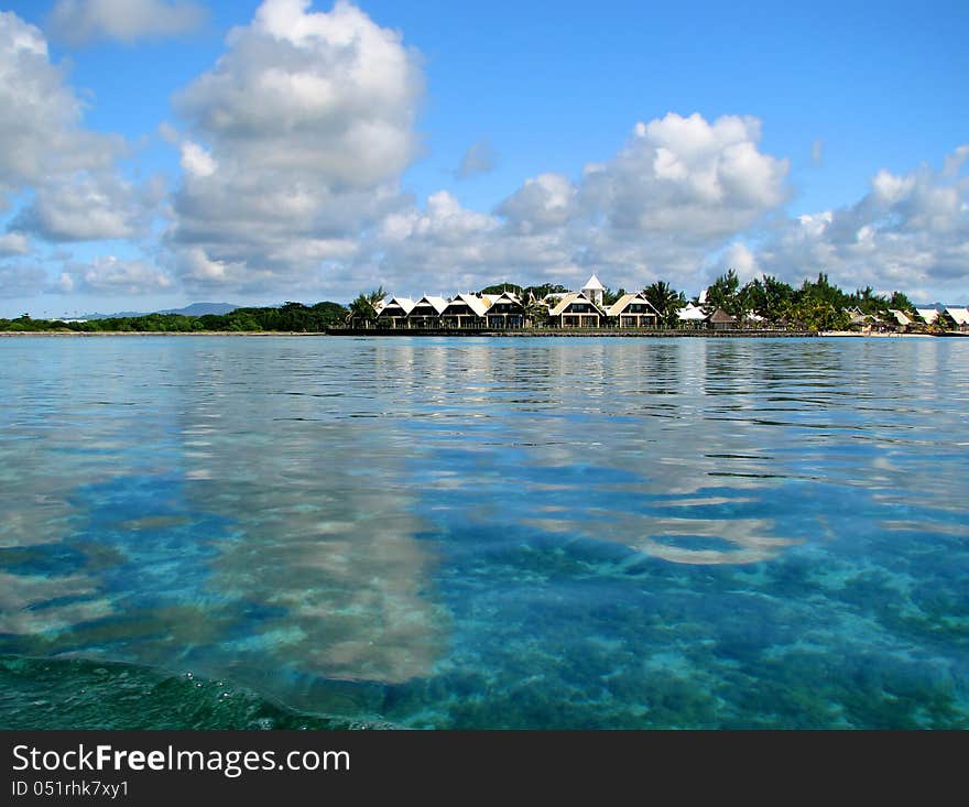 Small island in the smaragd lagoon with small houses. Small island in the smaragd lagoon with small houses.