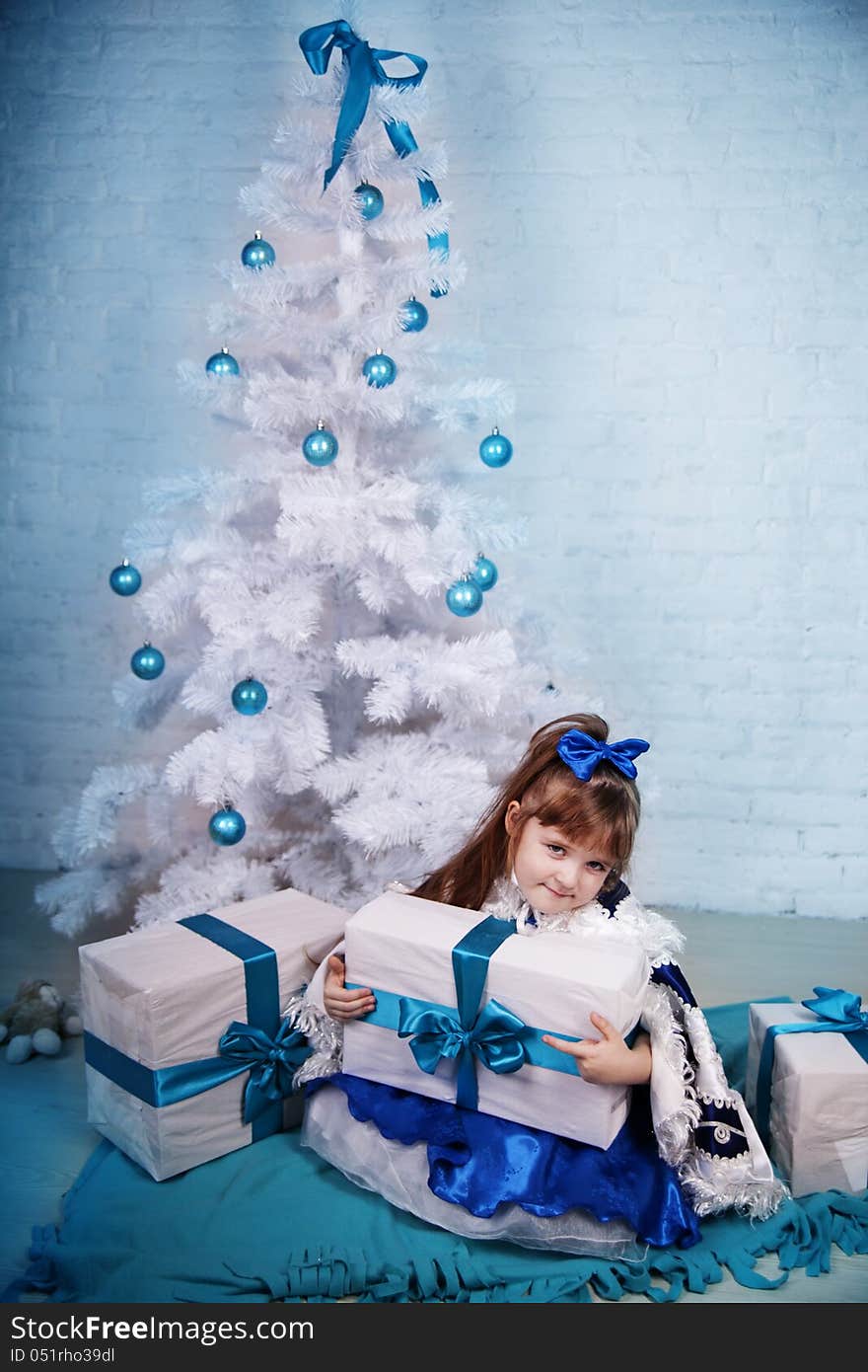 Cute girl near the Christmas tree. Cute girl near the Christmas tree