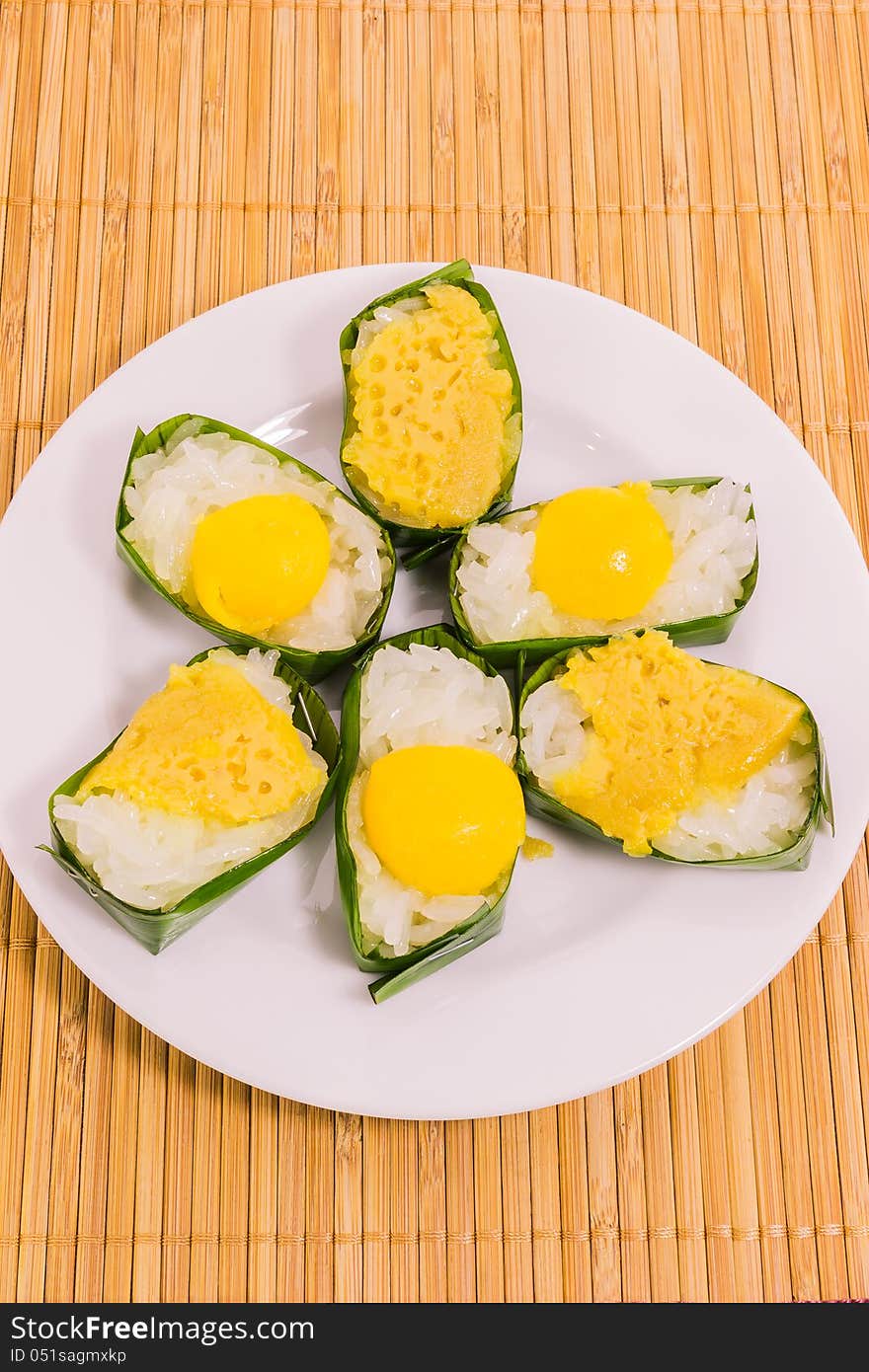 Thai dessert sticky rice with coconut custard packing by banana leaf