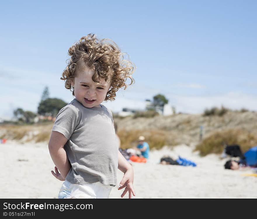 Small boy enjoying day at the beach, laughing,and happy. Small boy enjoying day at the beach, laughing,and happy.