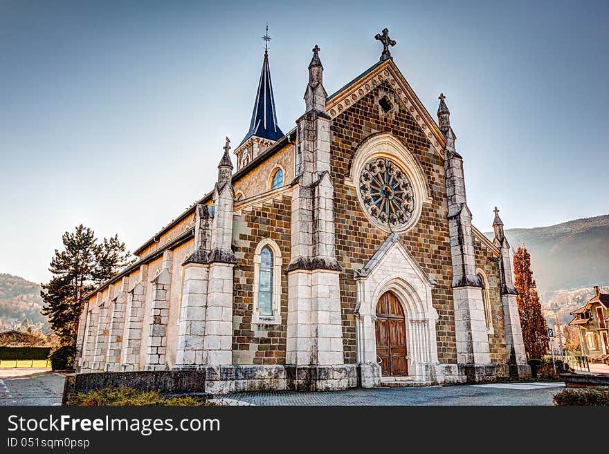 Church in the French Alps town of Saint-Jorioz on Lake Annecy. This is taken with the Alps in the background on a clear blue sunny winter day. Church in the French Alps town of Saint-Jorioz on Lake Annecy. This is taken with the Alps in the background on a clear blue sunny winter day.