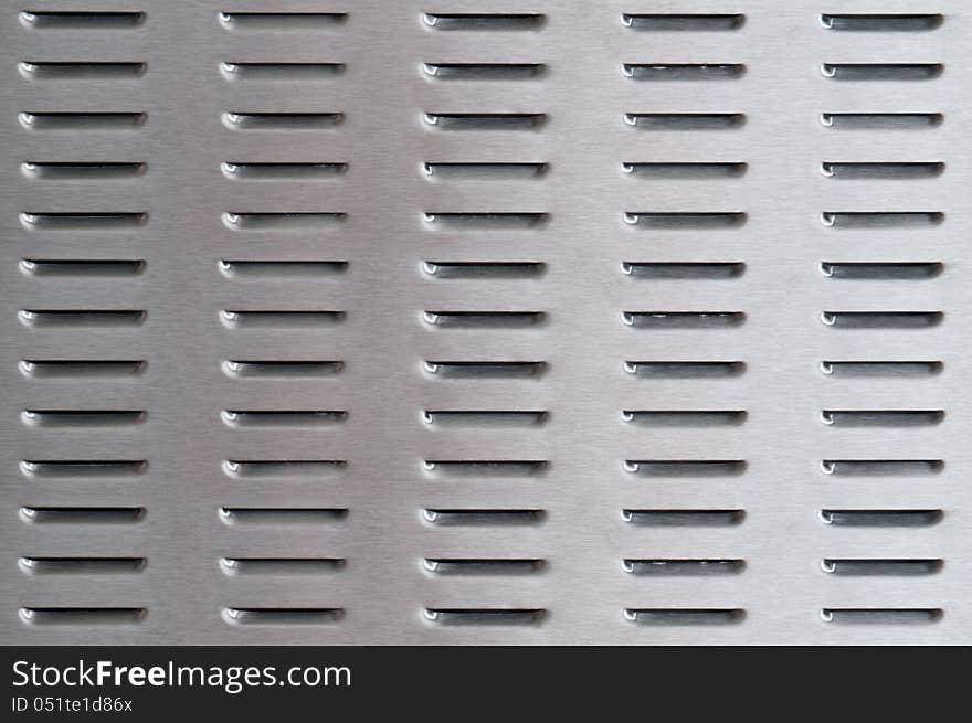 Perforated brushed metal surface background. Perforated brushed metal surface background