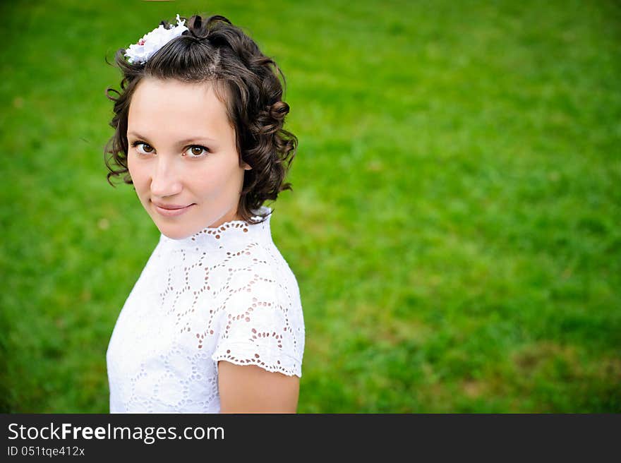 Portrait of beautiful young woman on the green grass background. Portrait of beautiful young woman on the green grass background