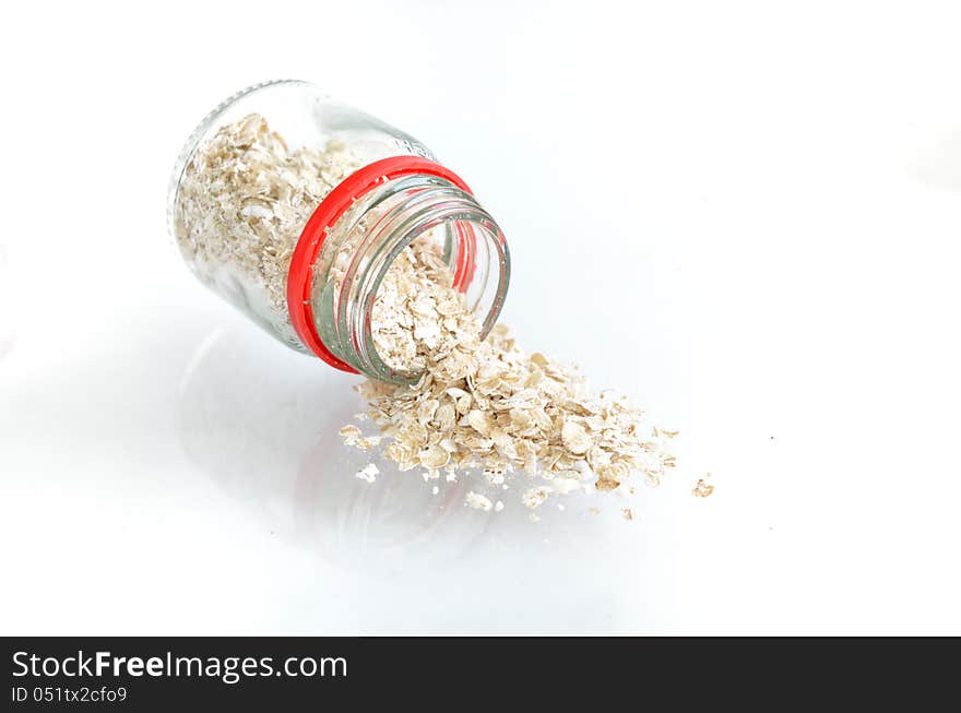 Oatmeal flakes with bottle  on white