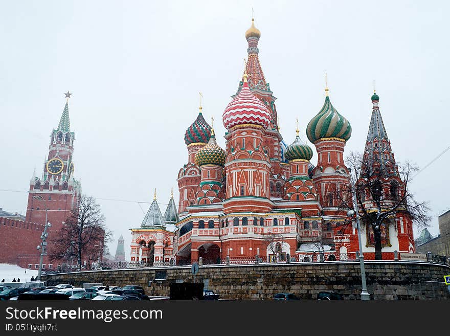 St Basil Temple and Spasskaya Tower of Kremlin at wintertime during snowfall. The Red Square, Moscow, Russia. St Basil Temple and Spasskaya Tower of Kremlin at wintertime during snowfall. The Red Square, Moscow, Russia