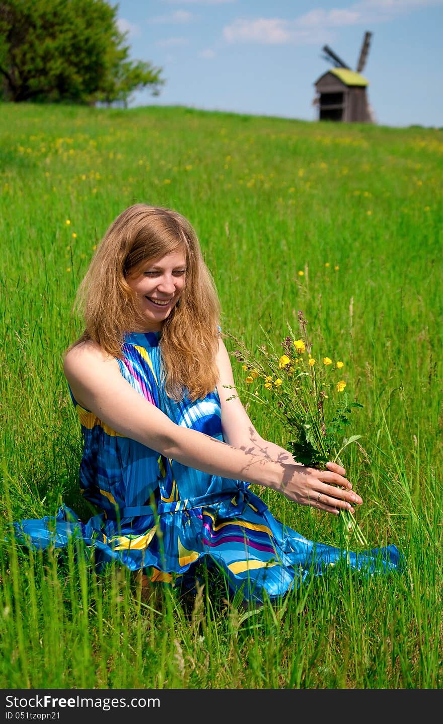 Women in field with wild flowers bouquet. Women in field with wild flowers bouquet